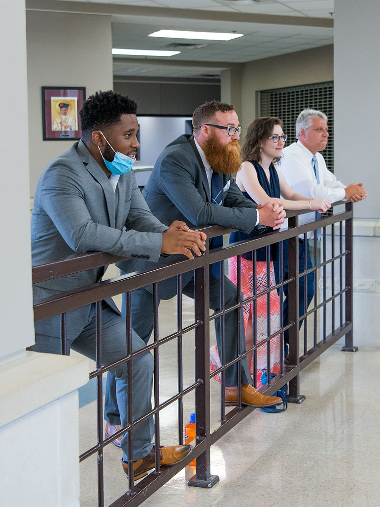 From left, Jeremy Osborne, Josh Giliberto, Samantha Baratta, and Chuck Register greet students